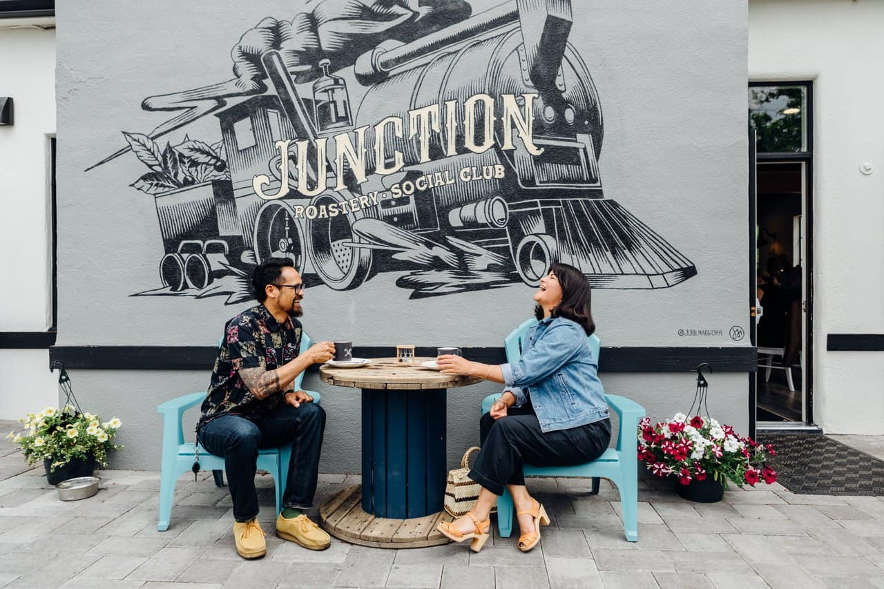 Couple enjoys coffee at Junction Roastery and Social Club Couple enjoys coffee at Junction Roastery and Social Club