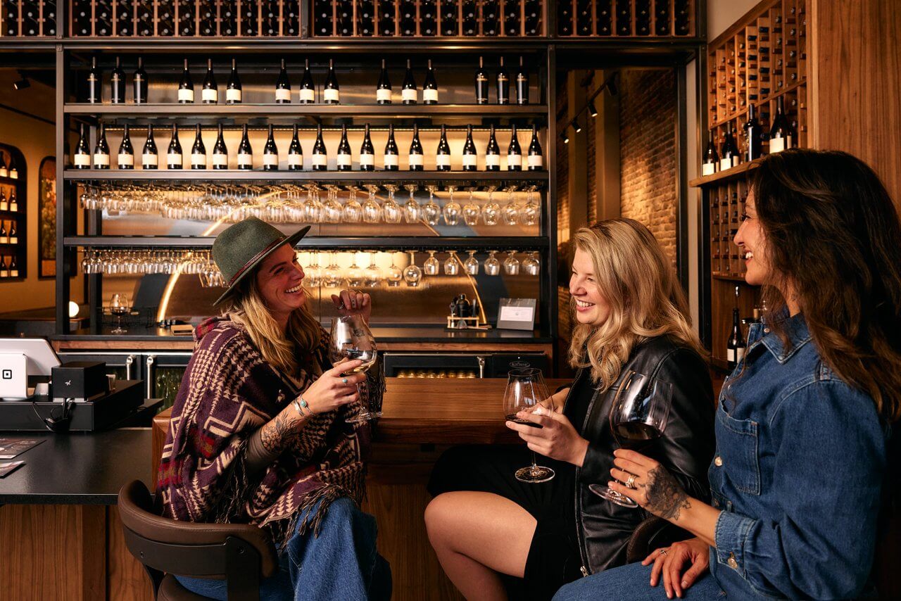 Women having wine at the bar at Willamette Valley Vineyards tasting room. Women having wine at the bar at Willamette Valley Vineyards tasting room.