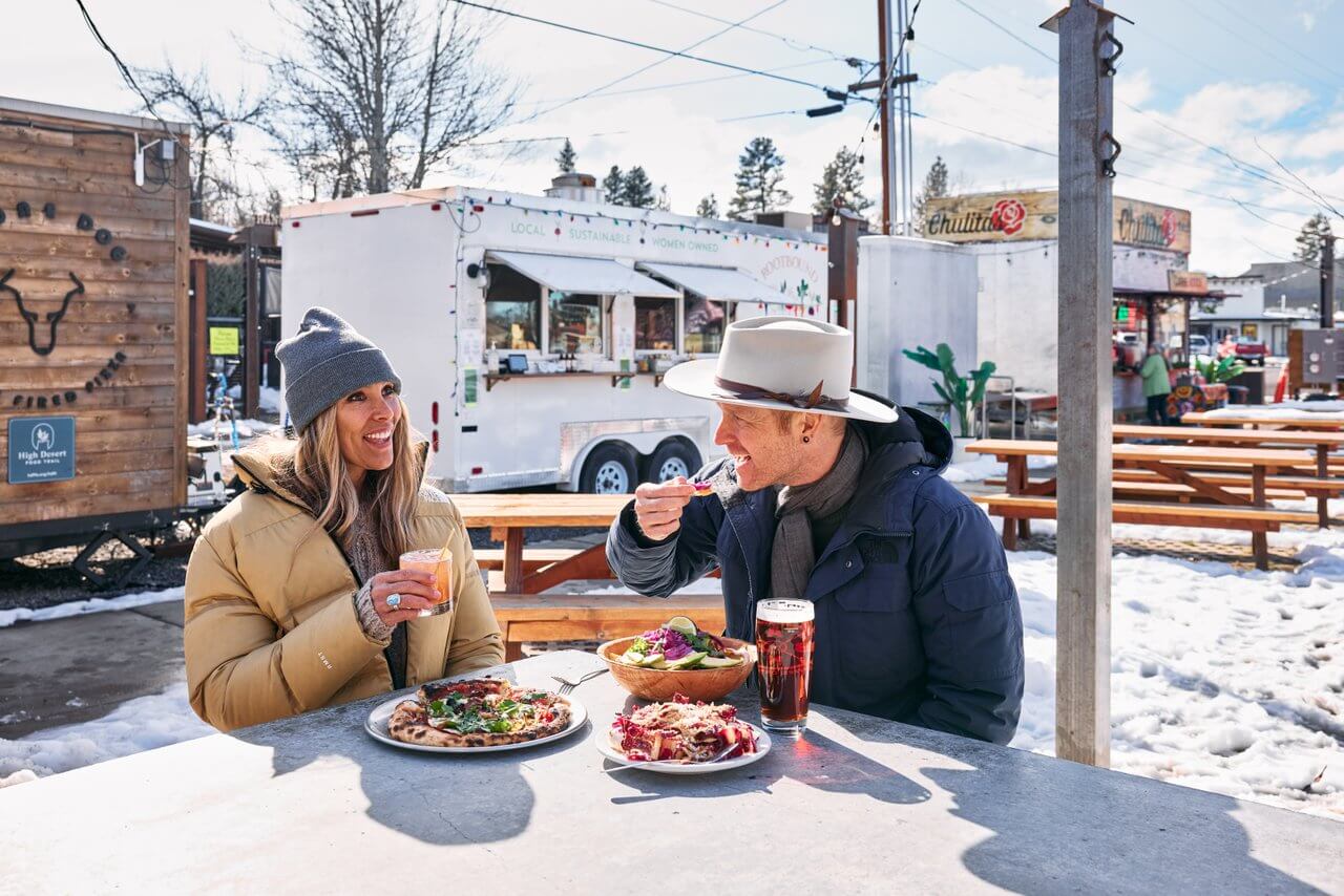 Couple dining at The Barn food cart pod in Sisters, Oregon Couple dining at The Barn food cart pod in Sisters, Oregon