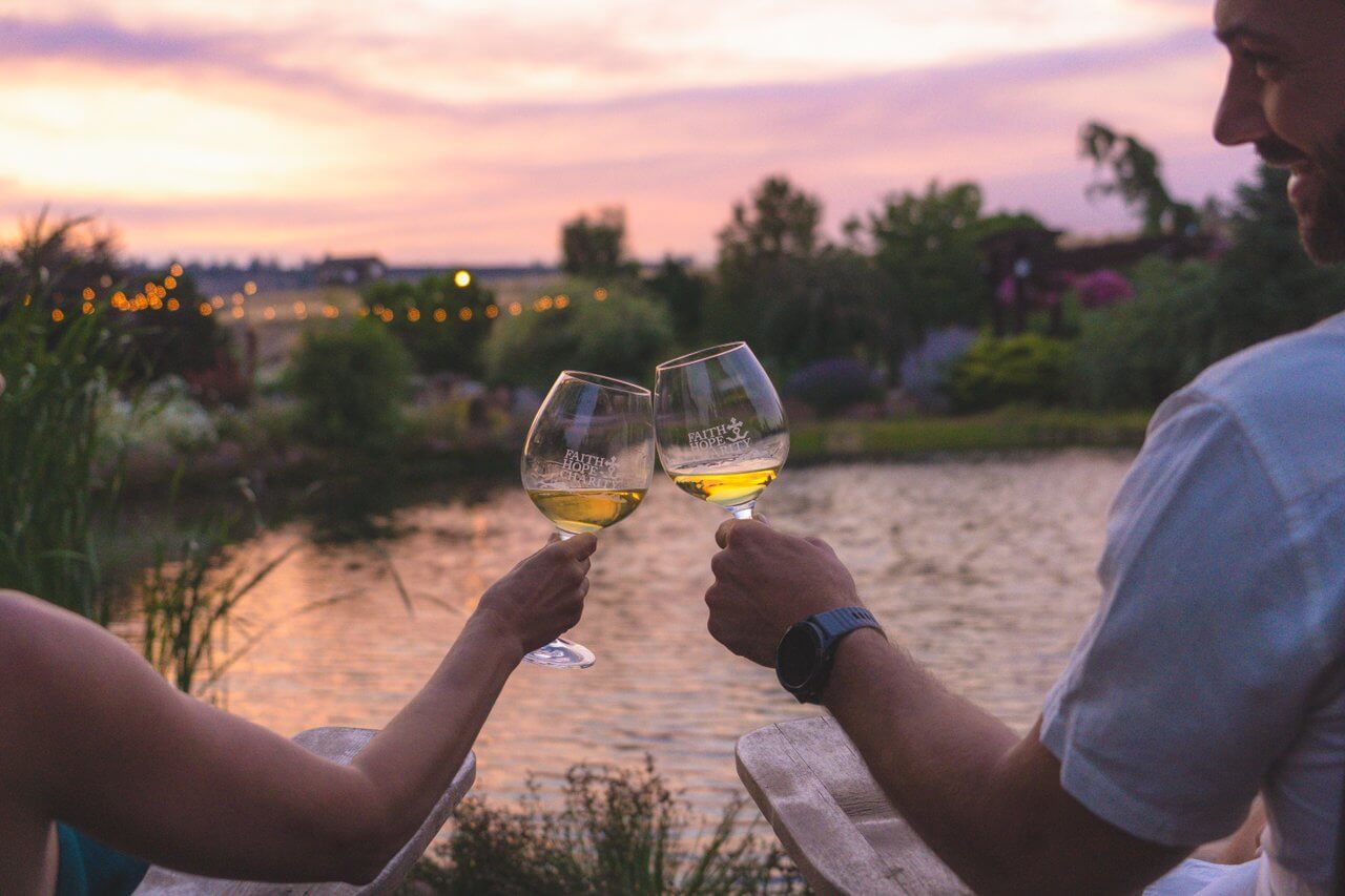 Wine glasses clinking at Faith Hope & Charity Vineyards. Wine glasses clinking at Faith Hope & Charity Vineyards.