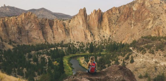 A woman sits on a rock high above the Crooked River and Smith Rock State Park in Terrebonne, Oregon. A woman sits on a rock high above the Crooked River and Smith Rock State Park in Terrebonne, Oregon.