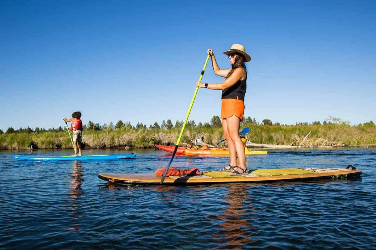 A family paddleboards down the Deschutes River. A family paddleboards down the Deschutes River.