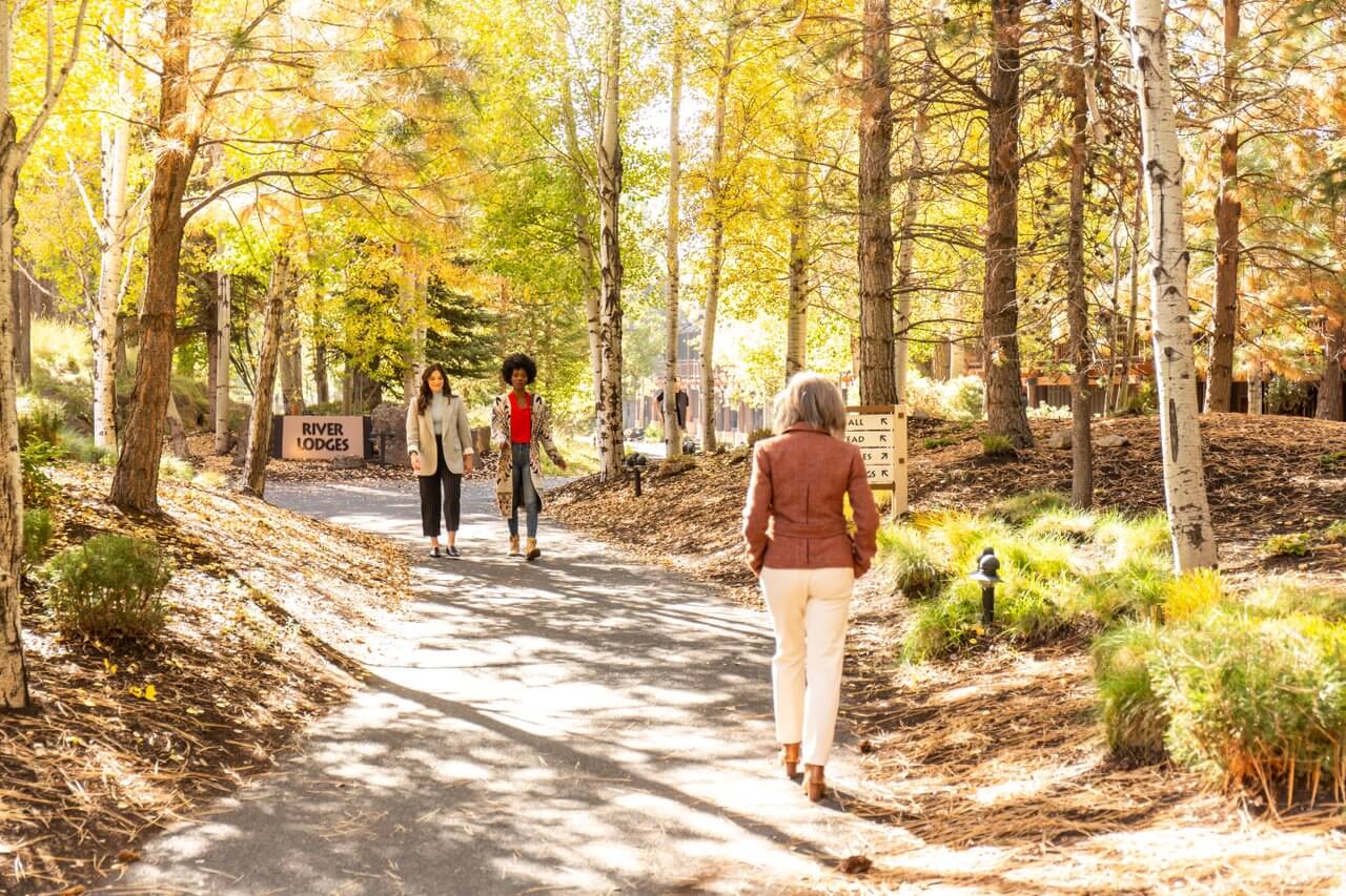 Women walking on path surrounded by fall trees. Women walking on path surrounded by fall trees.