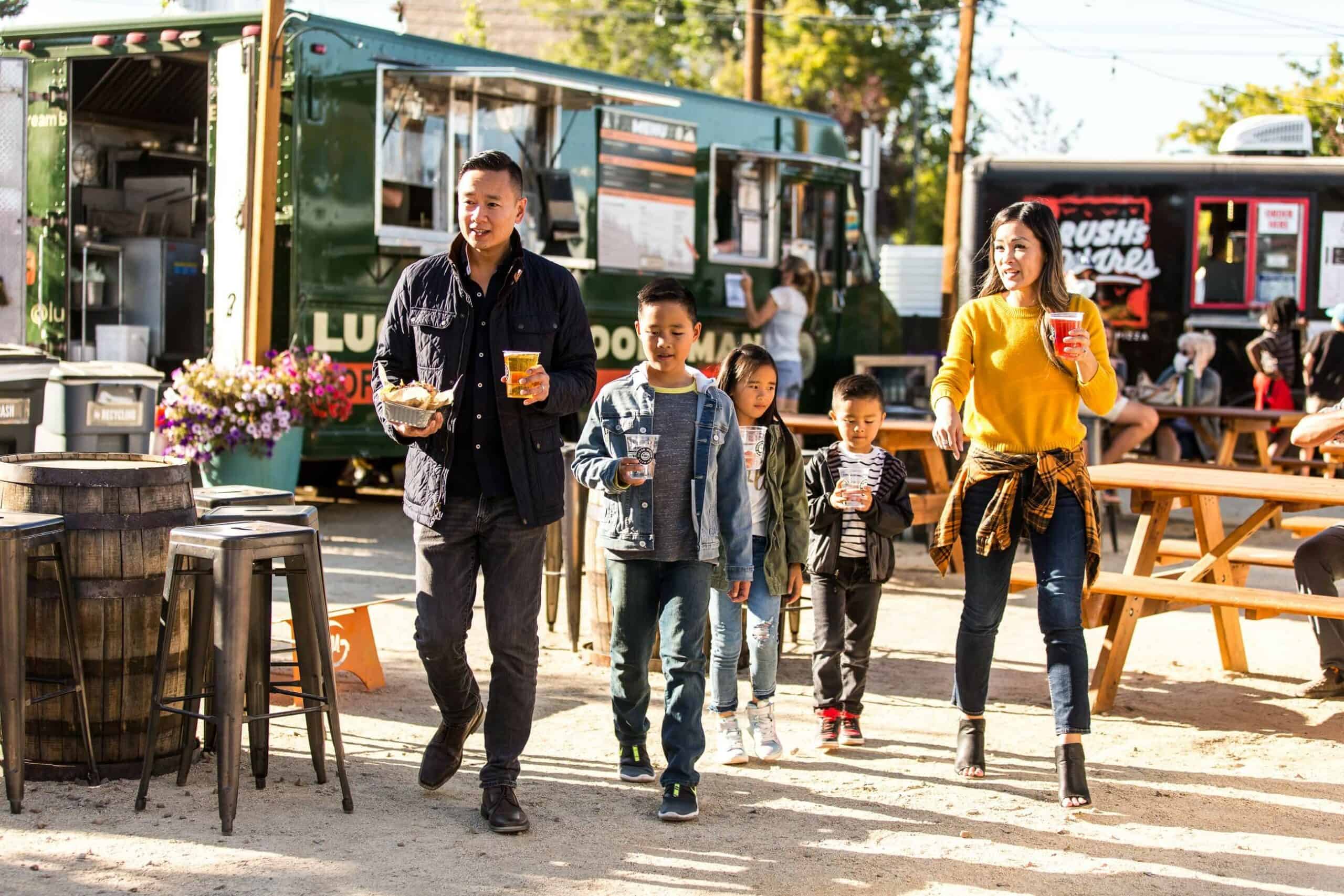 a family grabbing food at the food carts a family grabbing food at the food carts