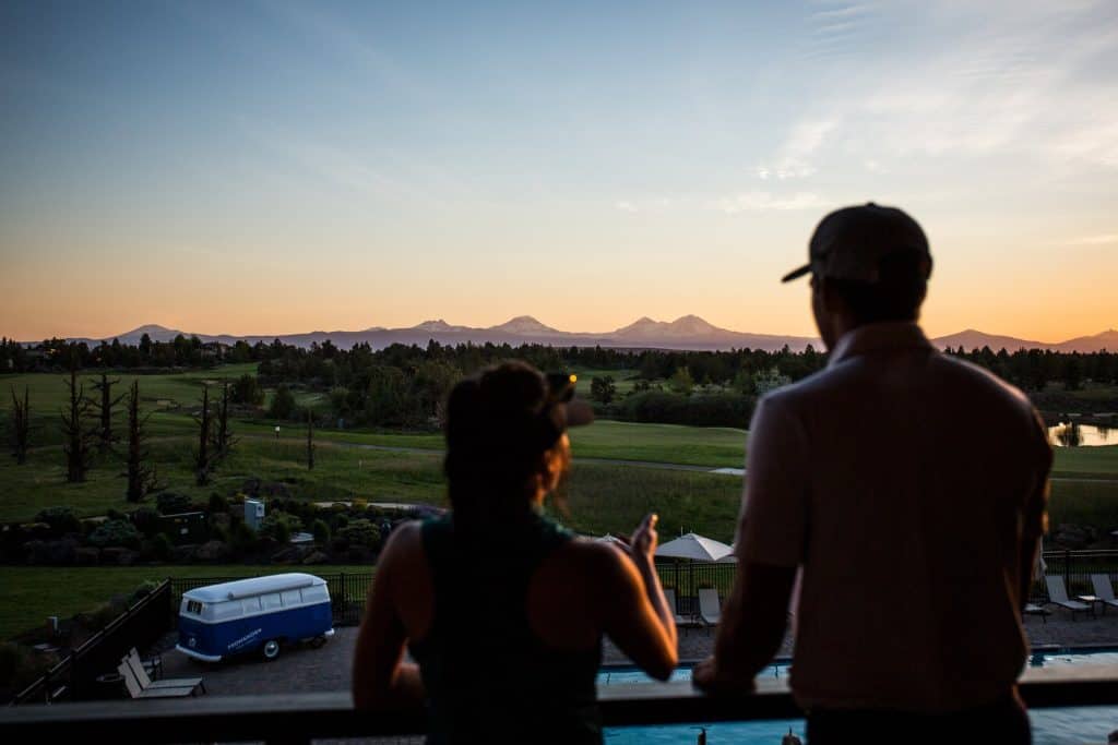 steve heinrichs photography-95-large Two people admire the golf course and landscape from a balcony at Pronghorn Resort